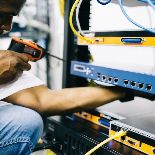 Black technician servicing hardware in a data centre