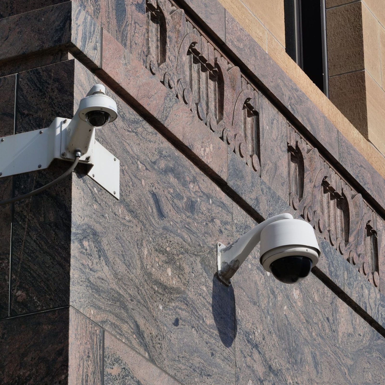 Modern surveillance cameras mounted on a building
