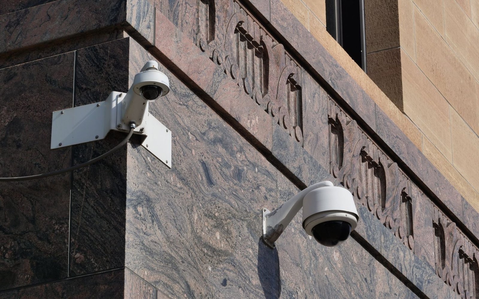 Modern surveillance cameras mounted on a building