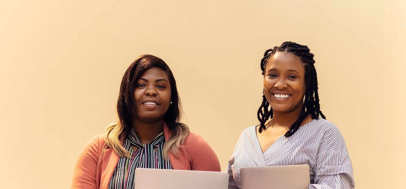 African businesswomen collaborating with laptops