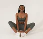 Black woman practising seated yoga