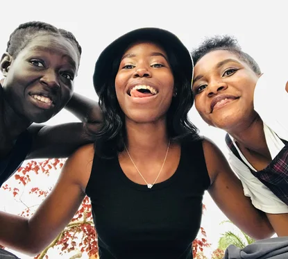 Three friends together outdoors in Kampala