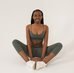 Black woman practising seated yoga