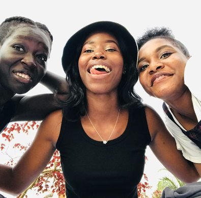 Three friends together outdoors in Kampala