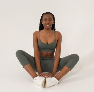 Black woman practising seated yoga