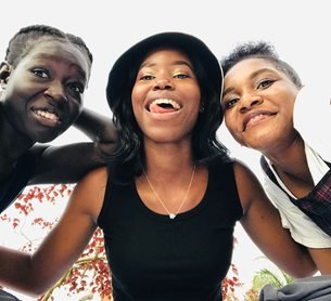Three friends together outdoors in Kampala
