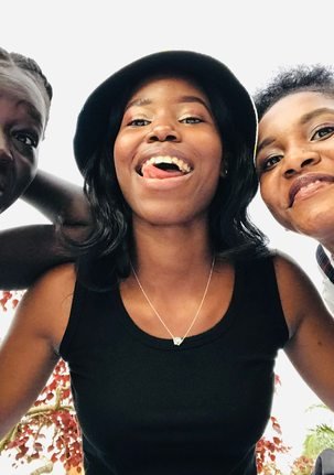 Three friends together outdoors in Kampala