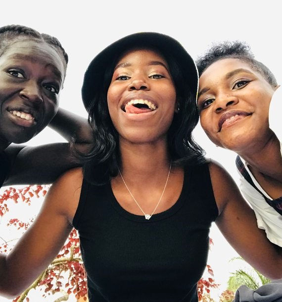 Three friends together outdoors in Kampala