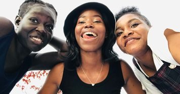 Three friends together outdoors in Kampala