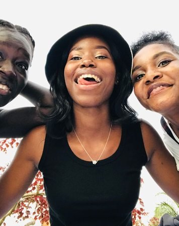 Three friends together outdoors in Kampala