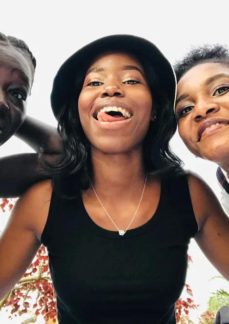 Three friends together outdoors in Kampala