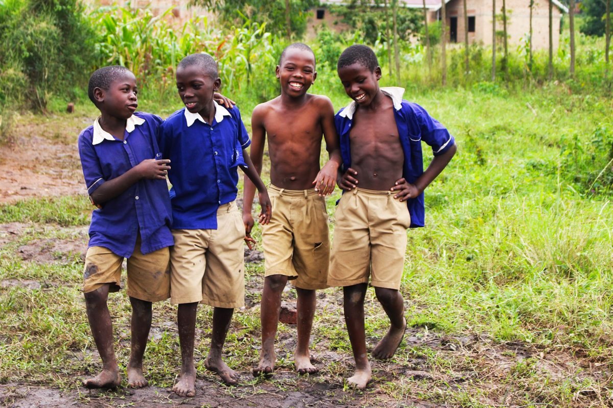 Schoolchildren in uniform smiling together in Uganda