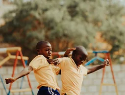 Children playing football in a Kampala schoolyard