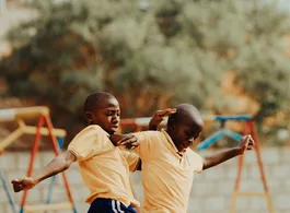 Children playing football in a Kampala schoolyard
