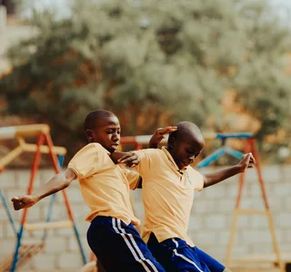 Children playing football in a Kampala schoolyard