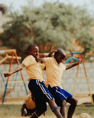 Children playing football in a Kampala schoolyard