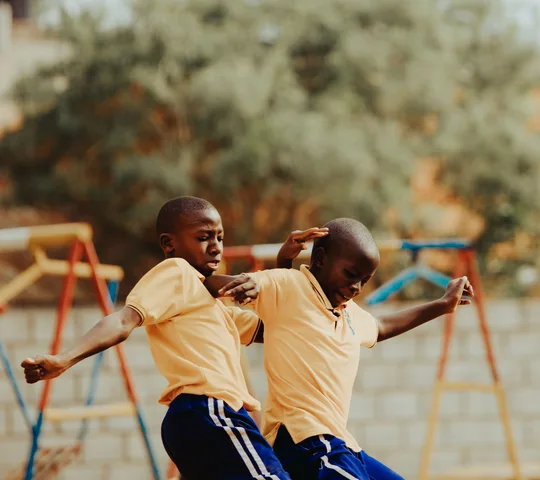 Children playing football in a Kampala schoolyard