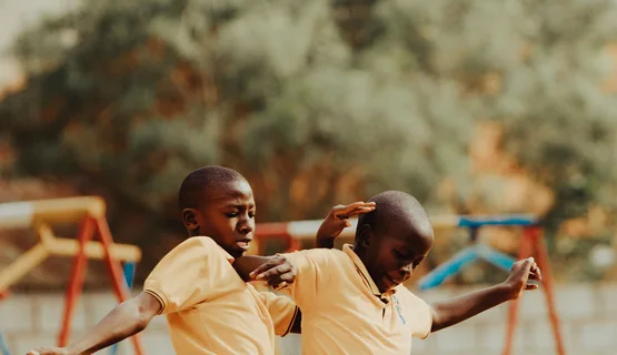 Children playing football in a Kampala schoolyard