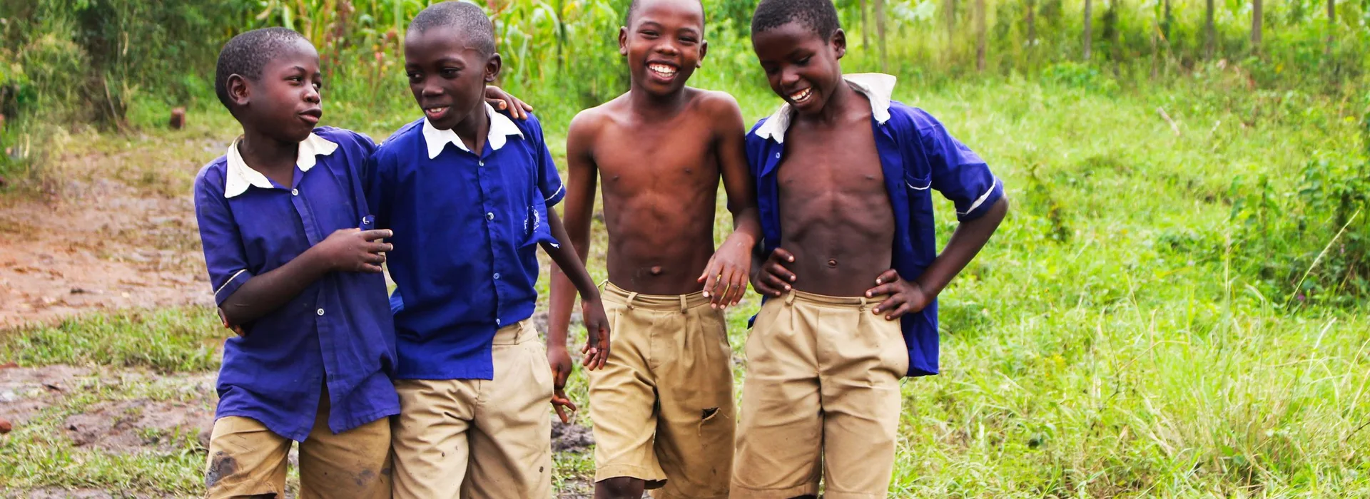 Schoolchildren in uniform smiling together in Uganda