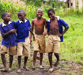 Schoolchildren in uniform smiling together in Uganda