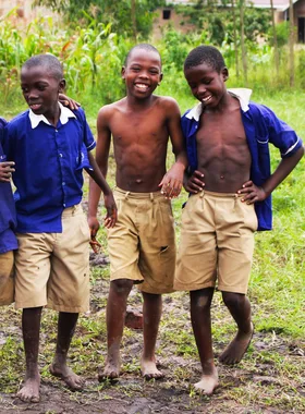 Schoolchildren in uniform smiling together in Uganda