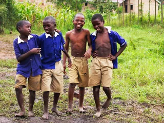 Schoolchildren in uniform smiling together in Uganda