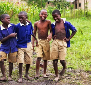 Schoolchildren in uniform smiling together in Uganda