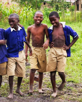 Schoolchildren in uniform smiling together in Uganda