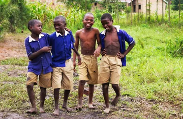 Schoolchildren in uniform smiling together in Uganda