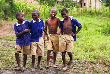 Schoolchildren in uniform smiling together in Uganda