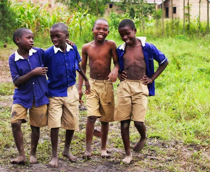 Schoolchildren in uniform smiling together in Uganda
