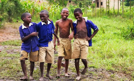 Schoolchildren in uniform smiling together in Uganda