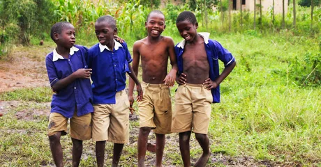 Schoolchildren in uniform smiling together in Uganda