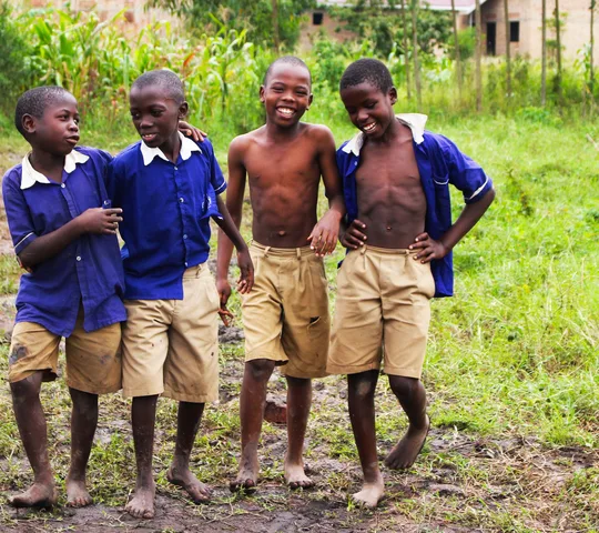 Schoolchildren in uniform smiling together in Uganda