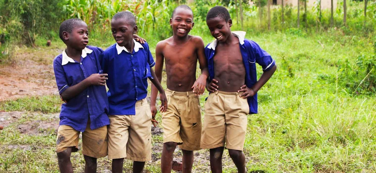 Schoolchildren in uniform smiling together in Uganda