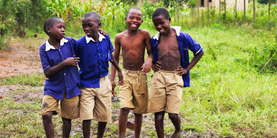 Schoolchildren in uniform smiling together in Uganda